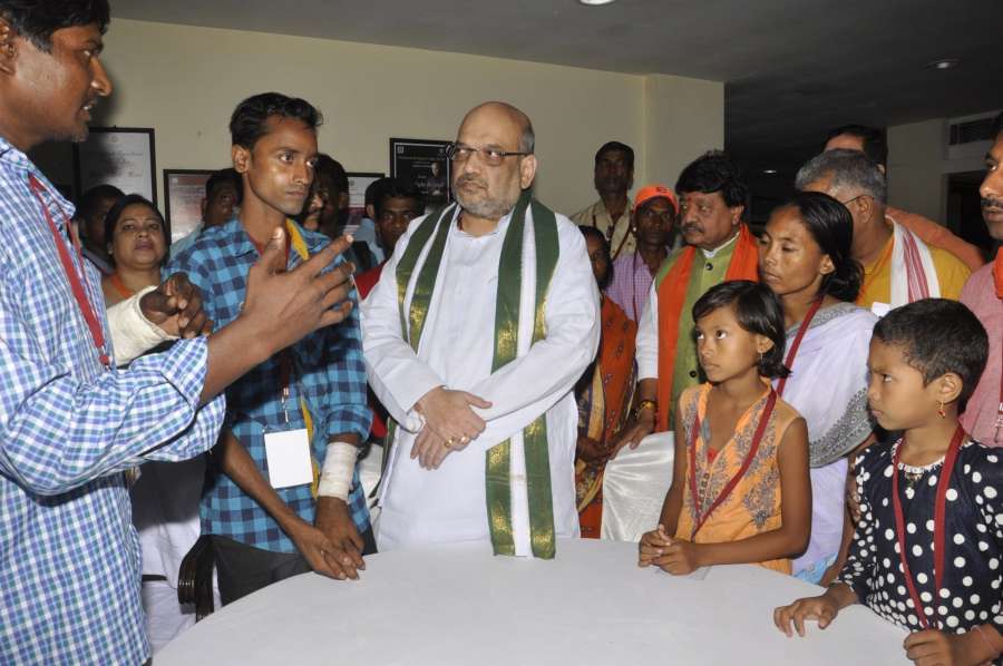 Kolkata: BJP President Amit Shah meets BJP workers and their families who were victims of political violence in West Bengal, in Kolkata on Sep 12, 2017. (Photo: IANS) by .