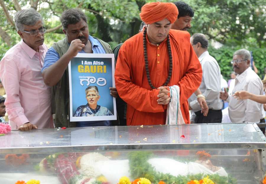 Bengaluru: Sadhus pay tribute during the public viewing of the mortal remains of Gauri Lankesh in Bengaluru on Sept 6, 2017. Editor of the weekly Kannada tabloid "Lankesh Patrika", Lankesh was shot dead by unidentified men at her residence on Sept 5, 2017. (Photo: IANS) by .