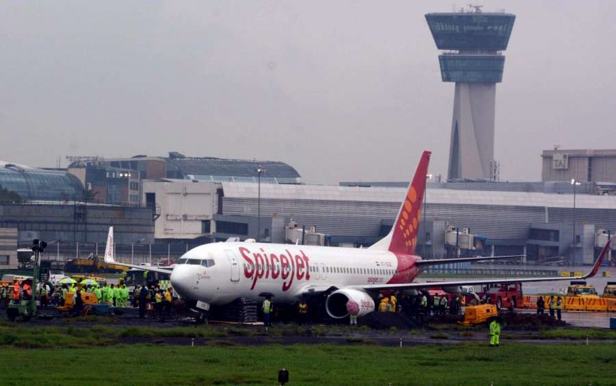 Mumbai: The Mumbai Airport's main runway remained closed as work on towing out a stranded SpiceJet airlines aircraft continued amid heavy rains, low visibility and strong winds at the Chhatrapati Shivaji International Airport in Mumbai on Sept 20, 2017. (Photo: IANS) by .