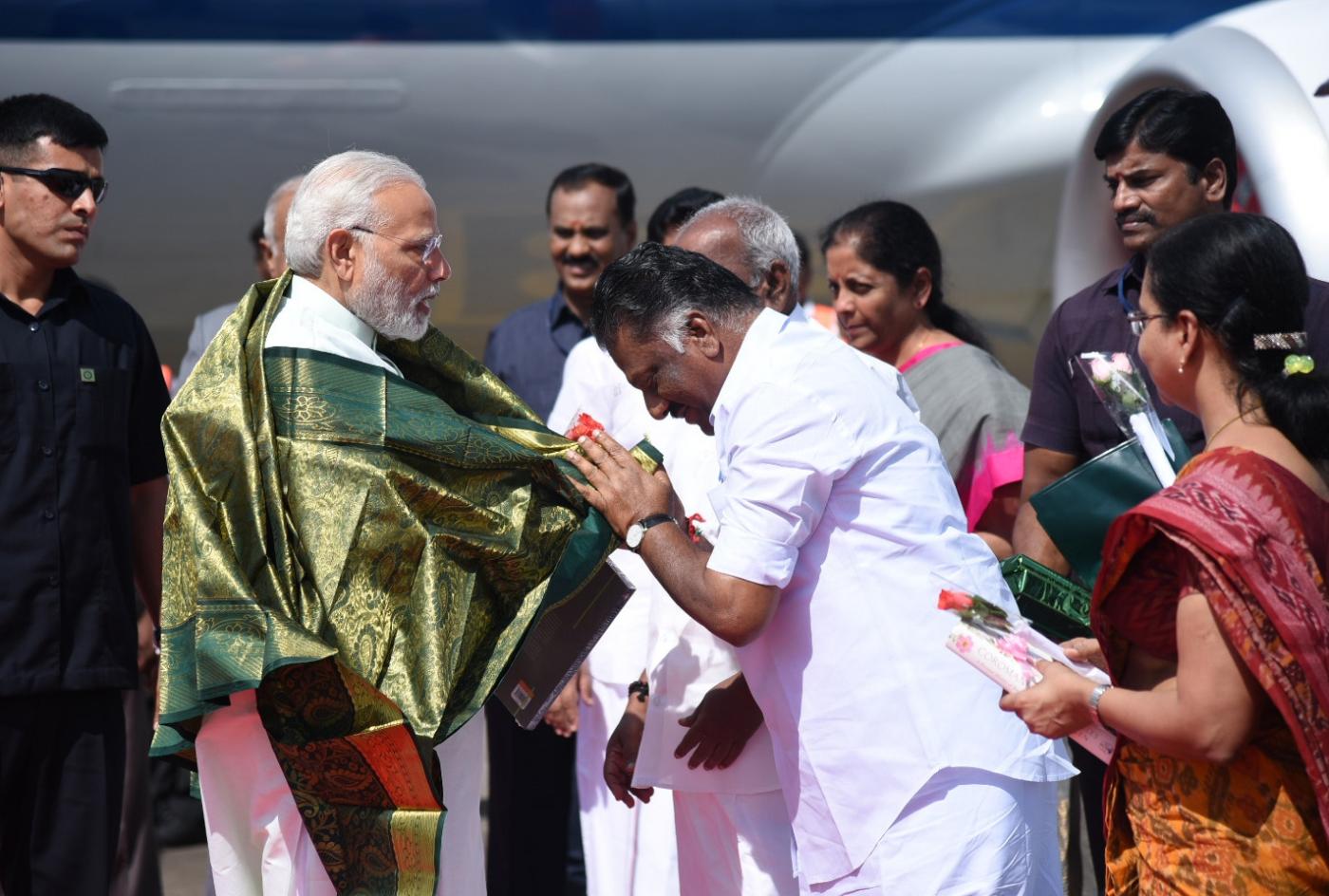 Chennai: Prime Minister Narendra Modi being welcomed by the Deputy Chief Minister of Tamil Nadu O. Panneerselvam, on his arrival, at Chennai, Tamil Nadu on April 12, 2018. (Photo: IANS/PIB) by . 