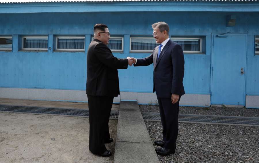 Panmunjom: South Korean President Moon Jae-in (R) and his North Korean counterpart Kim Jong-un shake hands across the military demarcation line prior to Kim's crossing into the South for talks at the Peace House of the truce village of Panmunjom on April 27, 2018. (Yonhap/IANS) by . 