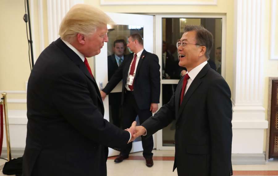 Hamburg: South Korean President Moon Jae-in shakes hands with U.S. President Donald Trump before a three-way meeting with Japanese Prime Minister Shinzo Abe at the U.S. consulate in Hamburg on July 6, 2017. (Yonhap/IANS) by . 