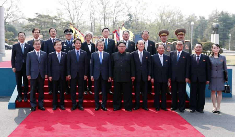 Panmunjom: South Korean President Moon Jae-in (4th from L) and his North Korea counterpart Kim Jong-un (5th from L) pose for a photo with their entourages after a ceremony to welcome Kim prior to their talks at the Peace House of the truce village of Panmunjom on April 27, 2018. (Yonhap/IANS) by . 
