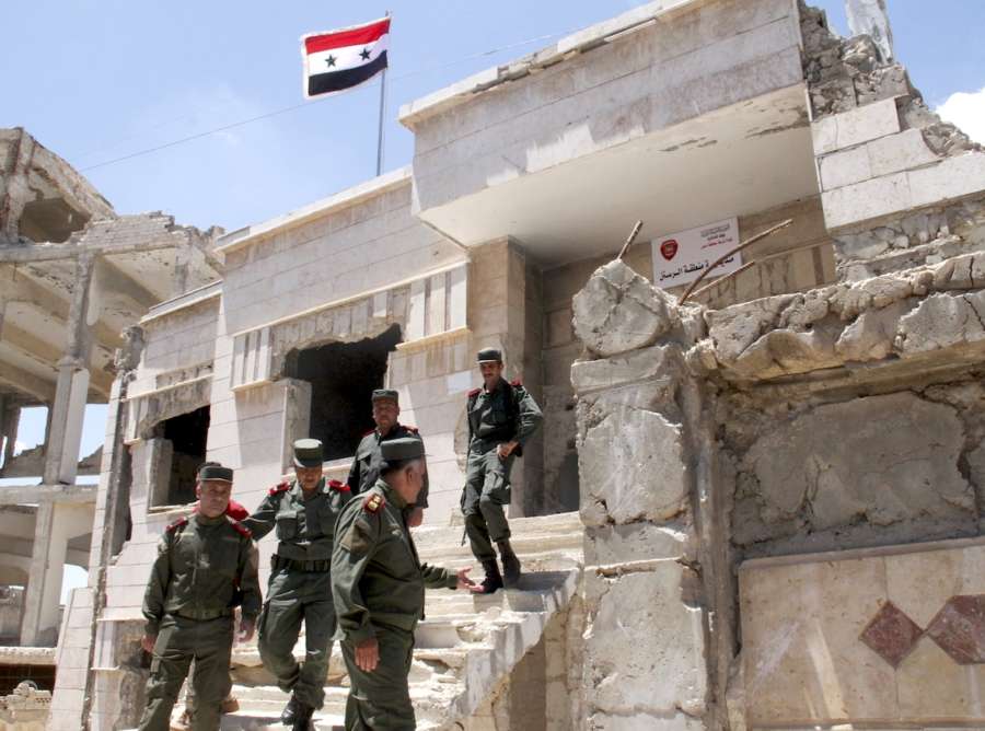 HOMS, May 16, 2018 (Xinhua) -- Syrian policemen gather in front of a building in the city of Rastan, in the northern countryside of Homs province in central Syria, on May 16, 2018. The last batch of rebels and their families has been evacuated Wednesday out of Syria's central province of Homs, local officials told Xinhua. TO GO WITH Roundup:Last batch of rebels evacuate Syria's Homs (Xinhua/Hummam Sheikh Ali/IANS) by . 