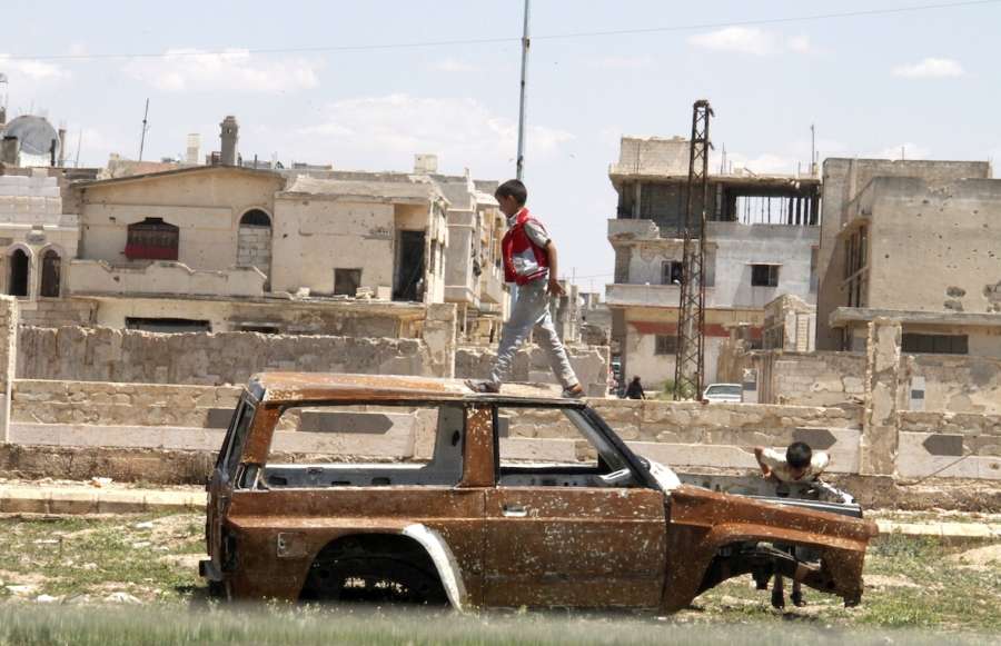 HOMS, May 16, 2018 (Xinhua) -- Syrian boys play on a damaged car in the city of Talbiseh, in the northern countryside of Homs province in central Syria, on May 16, 2018. The last batch of rebels and their families has been evacuated Wednesday out of Syria's central province of Homs, local officials told Xinhua. TO GO WITH Roundup:Last batch of rebels evacuate Syria's Homs (Xinhua/Hummam Sheikh Ali/IANS) by . 