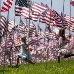 MALIBU, Sept. 11, 2018 (Xinhua) -- Children run among U.S. national flags erected to honor the victims of the September 11, 2001 attacks in New York, at the campus of Pepperdine University in Malibu, the United States, Sept. 10, 2018. (Xinhua/Zhao Hanrong/IANS) by . 