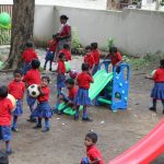 Children of both indigenous tribes and forest officers play together in the playground. by .