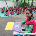A school teacher showing school homework of a nursery class tribal student. by .