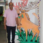Kanha's Assistant Director S.K. Khare, who gave up his bungalow for the school, stands beside the school mascot 'Bhoorsingh the Barasingha'. by . 