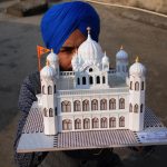 Amritsar: Paper artist Gurpreet Singh shows a model of Kartarpur Sahib, the final resting place of Guru Nank Dev, created by him, on the eve of the first Sikh Guru's birth anniversary, in Amritsar on Nov 22, 2018. (Photo: IANS) by .