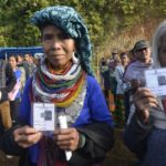 Mamit: Reang tribal refugees, sheltered in Tripura for the past 21 years, show their Voter ID cards as they arrive to cast their votes for Mizoram Assembly elections in Mamit district of Mizoram, on Nov 28, 2018. (Photo: IANS) by .