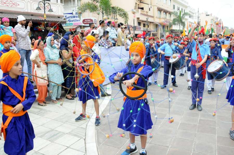 Amritsar: Sikh Nihangs perform 'Gatka' during a procession taken out to mark the 100th anniversary of the 1919 Jallianwala Bagh massacre, in Amritsar on April 12, 2019. (Photo: IANS) by .