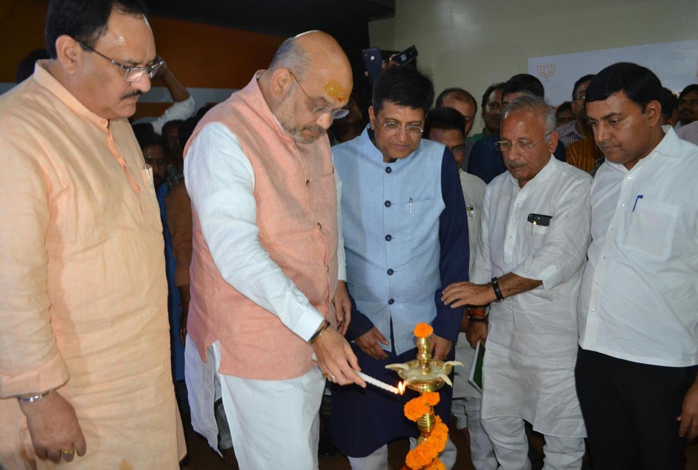 Varanasi: BJP President Amit Shah accompanied by Union Ministers Piyush Goyal and J.P. Nadda, lights the lamp to inaugurate BJP's office, in Varanasi, on April 24, 2019. (Photo: IANS) by .