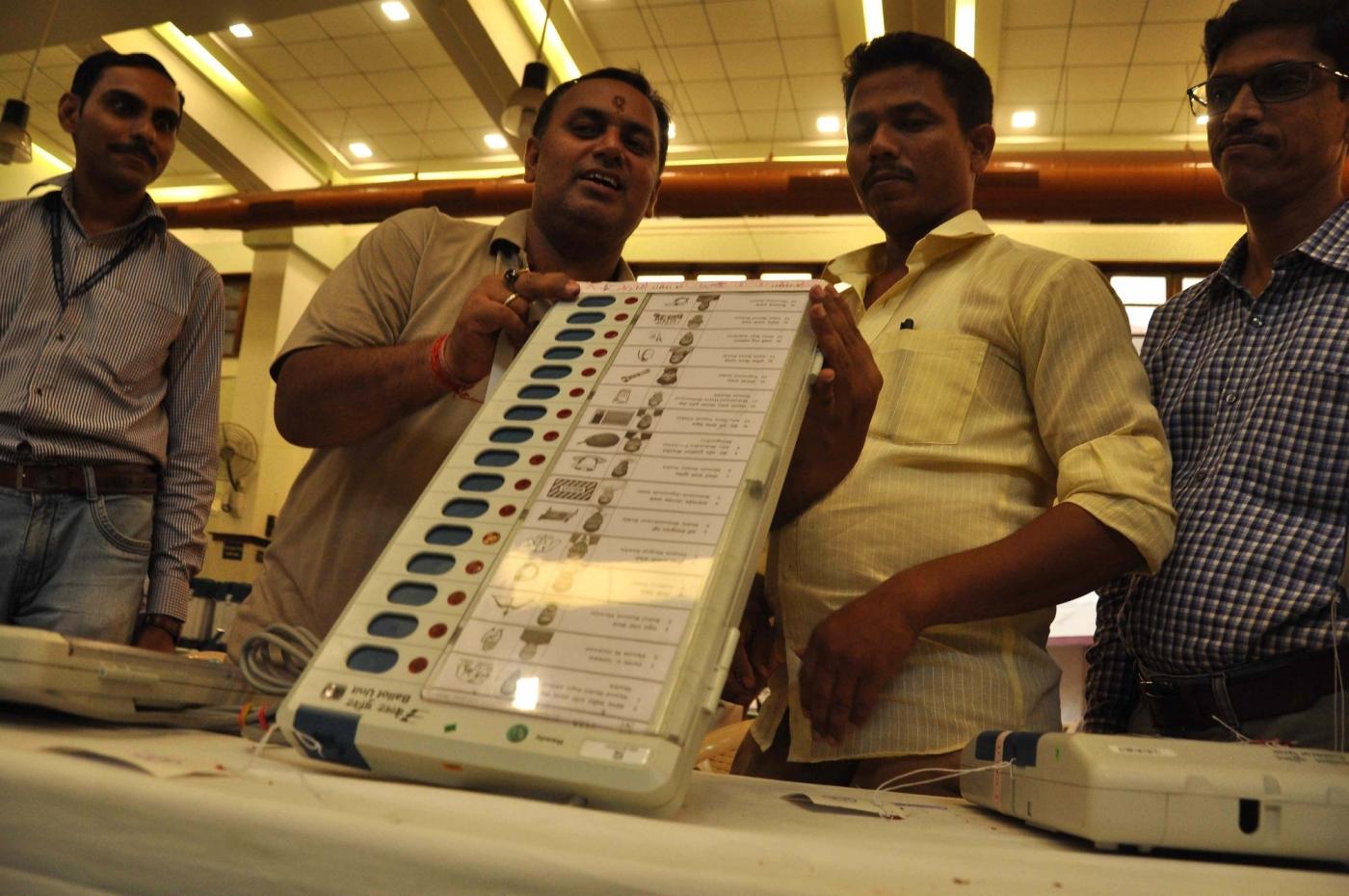 Mumbai: Polling officials check an Electronic Voting Machines (EVM) ahead of the 2019 Lok Sabha elections, at Dadar in Mumbai on April 22, 2019. (Photo: IANS) by . 