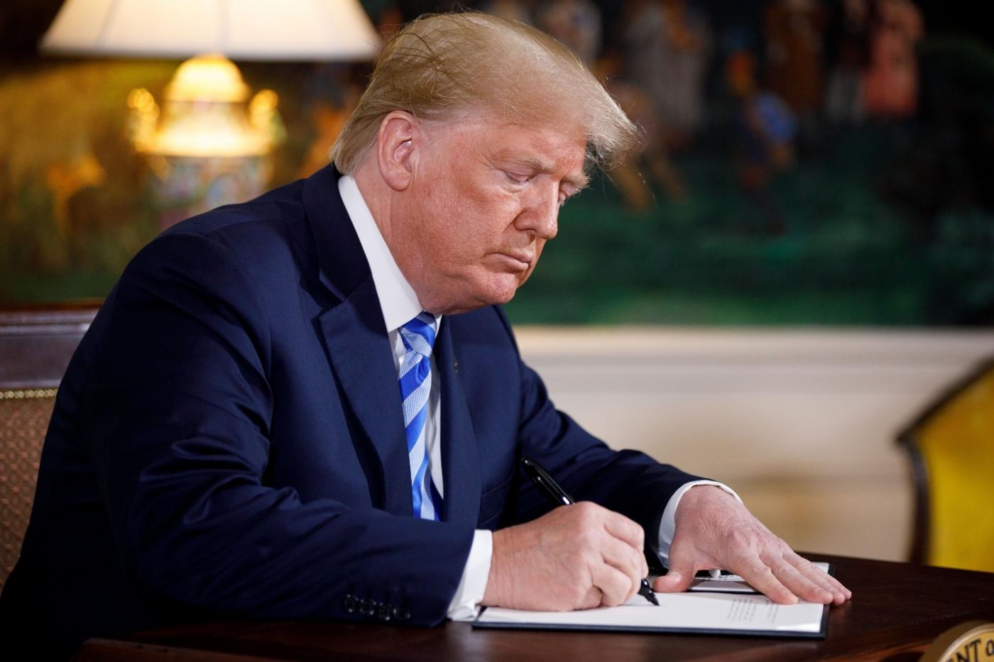 WASHINGTON, May 8, 2018 (Xinhua) -- U.S. President Donald Trump signs a presidential memorandum at the White House in Washington D.C., the United States, on May 8, 2018. U.S. President Donald Trump said here on Tuesday that the United States will withdraw from the Iran nuclear deal, a landmark agreement signed in 2015. (Xinhua/Ting Shen/IANS) by . 