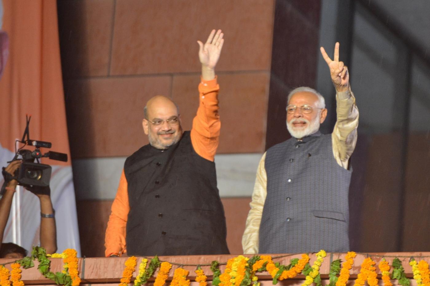 New Delhi: Prime Minister Narendra Modi and BJP chief Amit Shah wave at party workers during a party programme in New Delhi on May 23, 2019. (Photo: IANS) by .