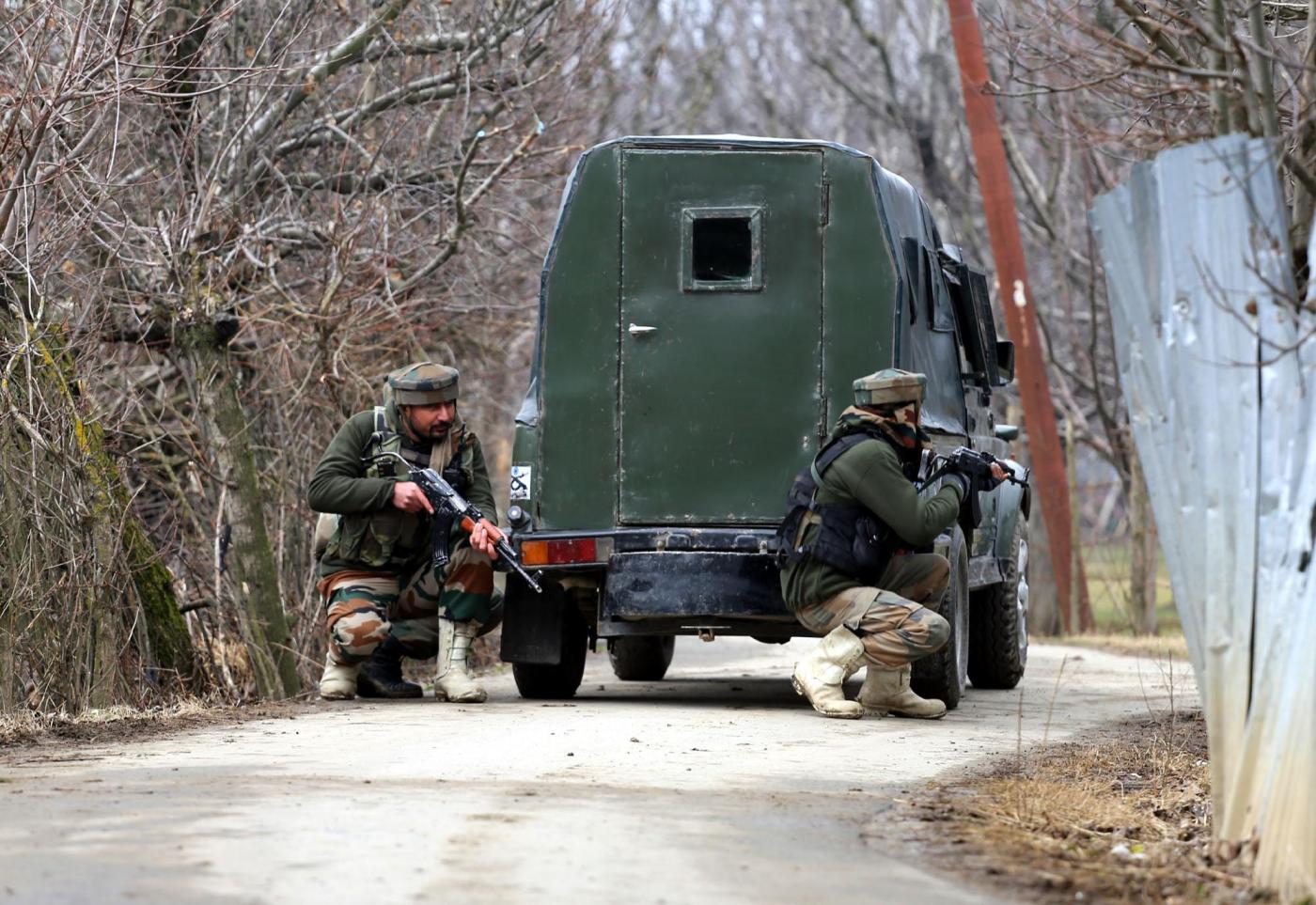 Sopore: Soldiers take position during a gun-battle with militants at Rehmatabad village in Jammu and Kashmir's Sopore district on Feb 21, 2015. Two foreign guerrillas belonging to the Lashkar-e-Taiba (LeT) group were killed in the encounter. (Photo: IANS) by . 