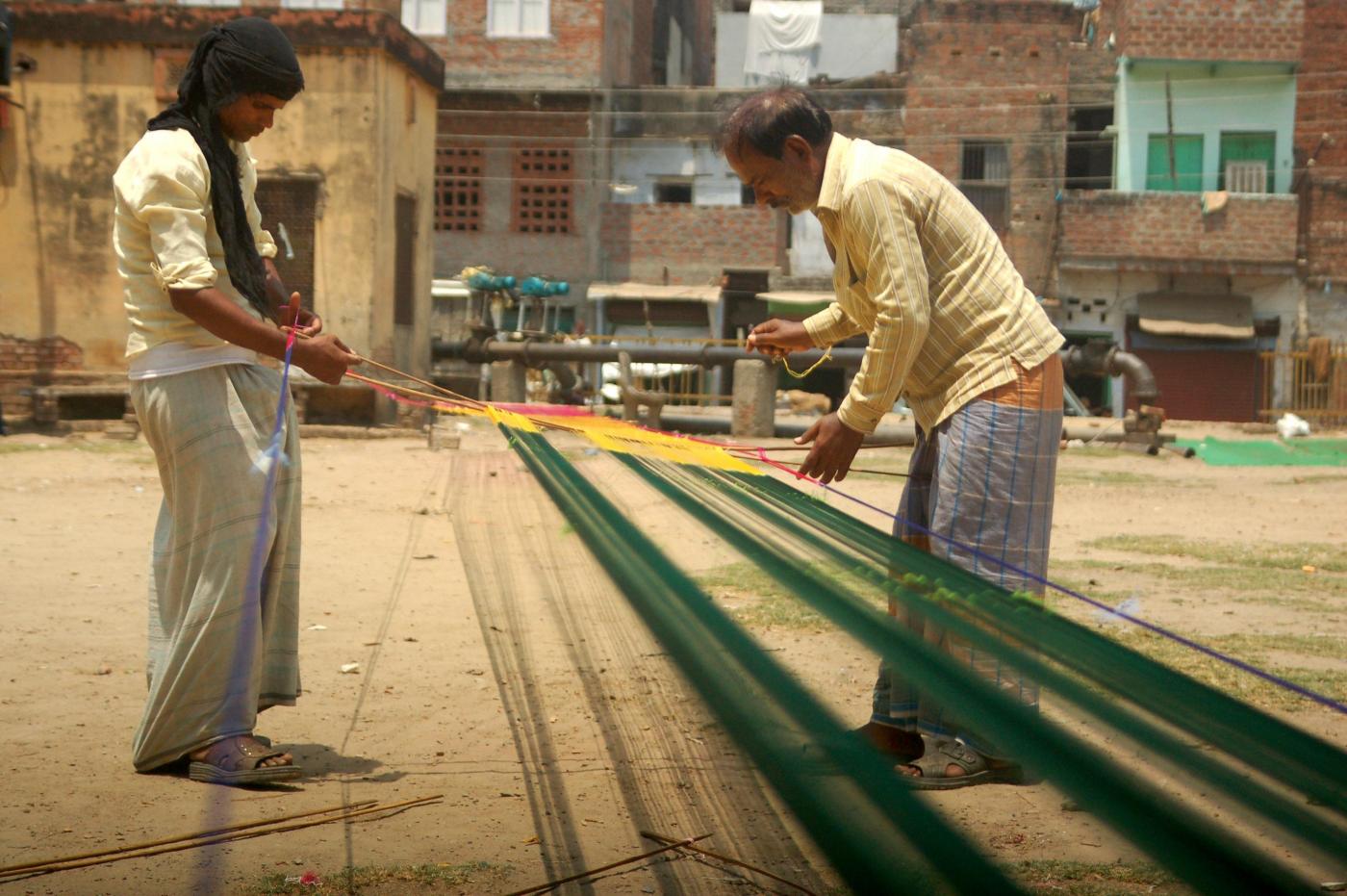 Weavers weave sarees even on International Workers' Day which is celebrated worldwide on 1st May to commemorate the historic struggle of workers for their rights, in Varanasi on May 1, 2014. (Photo: IANS) by . 
