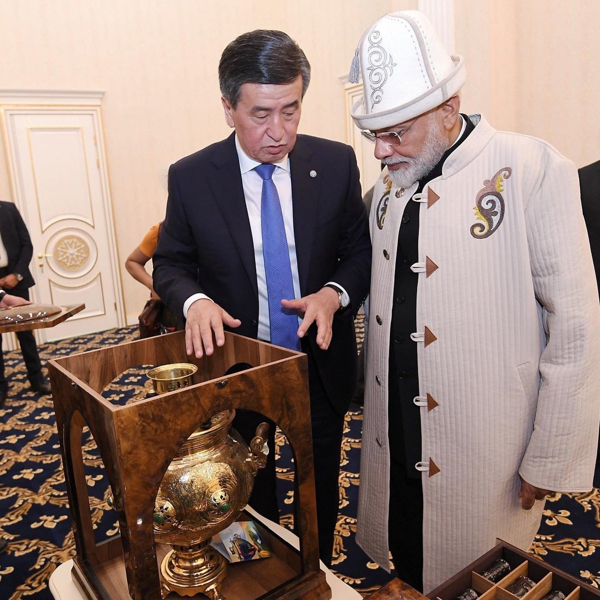 Bishkek: Kyrgyzstan President Sooronbay Jeenbekov presents a Kalpak, the traditional Kyrgyz hat, a Chapan a traditional coat from Kyrgyzstan and a Samovar a container to heat or boil water to Prime Minister Narendra Modi in Bishkek, on June 15, 2019. (Photo: IANS/@PMOIndia) by . 