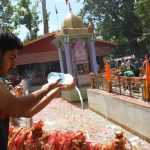 Srinagar: A devotee performs rituals during Kheer Bhawani Mela at Mata Kheer Bhawani Shrine in Jammu and Kashmir's Ganderbal district on June 20, 2018. Kashmiri Pandits started arriving here on Wednesday to pray for peace and prosperity at the shrine that is is dedicated to Hindu deity Mata Ragnya, who according to Hindu beliefs came to Kashmir from Sri Lanka during the rule of Ravana and is considered to be the holiest Kashmiri Pandit shrine in Kashmir Valley. (Photo: IANS) by . 