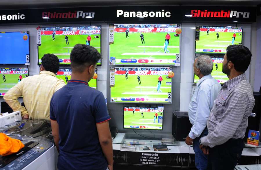Amritsar: People busy watching the 1st Semi-final match of 2019 World Cup between India and New Zealand underway at Manchester's Old Trafford; at an electronics showroom in Amritsar on July 10, 2019. (Photo: IANS) by . 