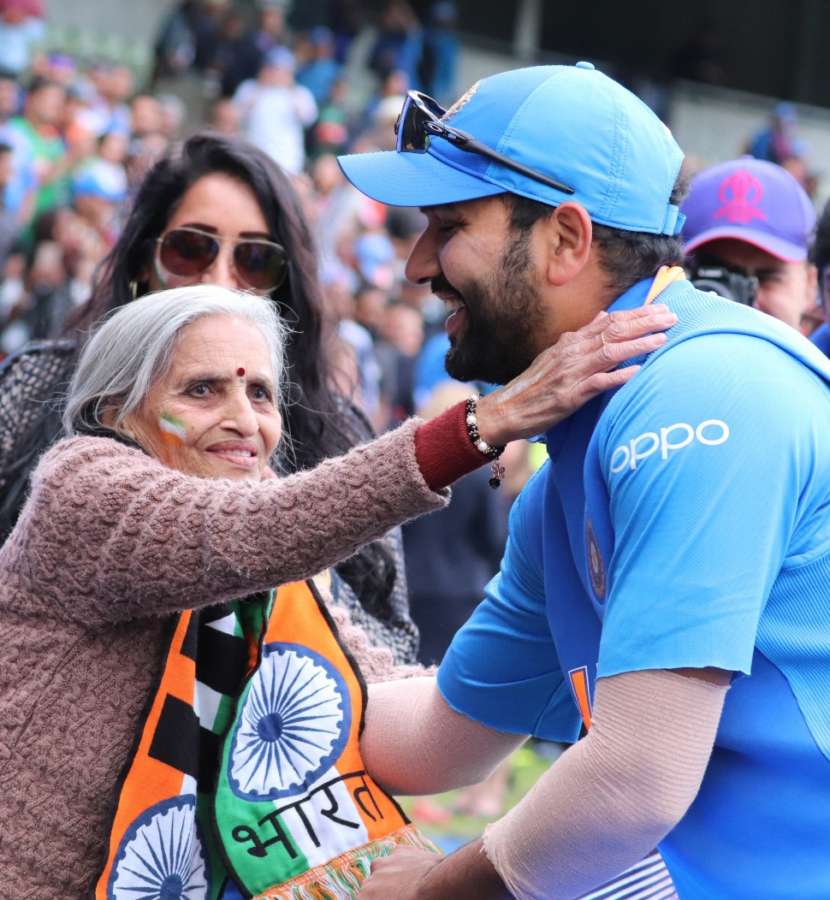 Birmingham: India opener Rohit Sharma greets 87-year-old Charulata Patel, who became a social media sensation after an image of her blowing a horn to cheer the Men in Blue during their World Cup match against Bangladesh went viral, at the Edgbaston Cricket Ground on July 2, 2019. âI have been watching cricket for last many decades. Earlier, I used to watch on TV when I was working, but now that I am retired I watch it live," she said. (Photo: IANS) by .