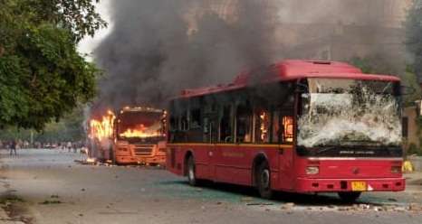 New Delhi: A bus set ablaze after a scuffle that broke out between the Delhi Police and Students of Jamia Millia Islamia in New Delhi on Dec 15, 2019. (Photo: IANS) by .
