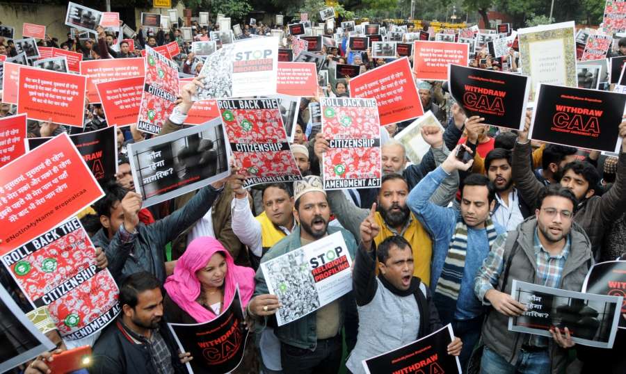 New Delhi: Social activists stage a demonstration against the Citizenship Amendment Act (CAA) 2019 during "#NotInMyName #repealcaa" protest rally, expressing solidarity with the students of Jamia Millia Islamia University who sustained injuries after they were lathi-charged by the police, in New Delhi on Dec 14, 2019. (Photo: IANS) by .