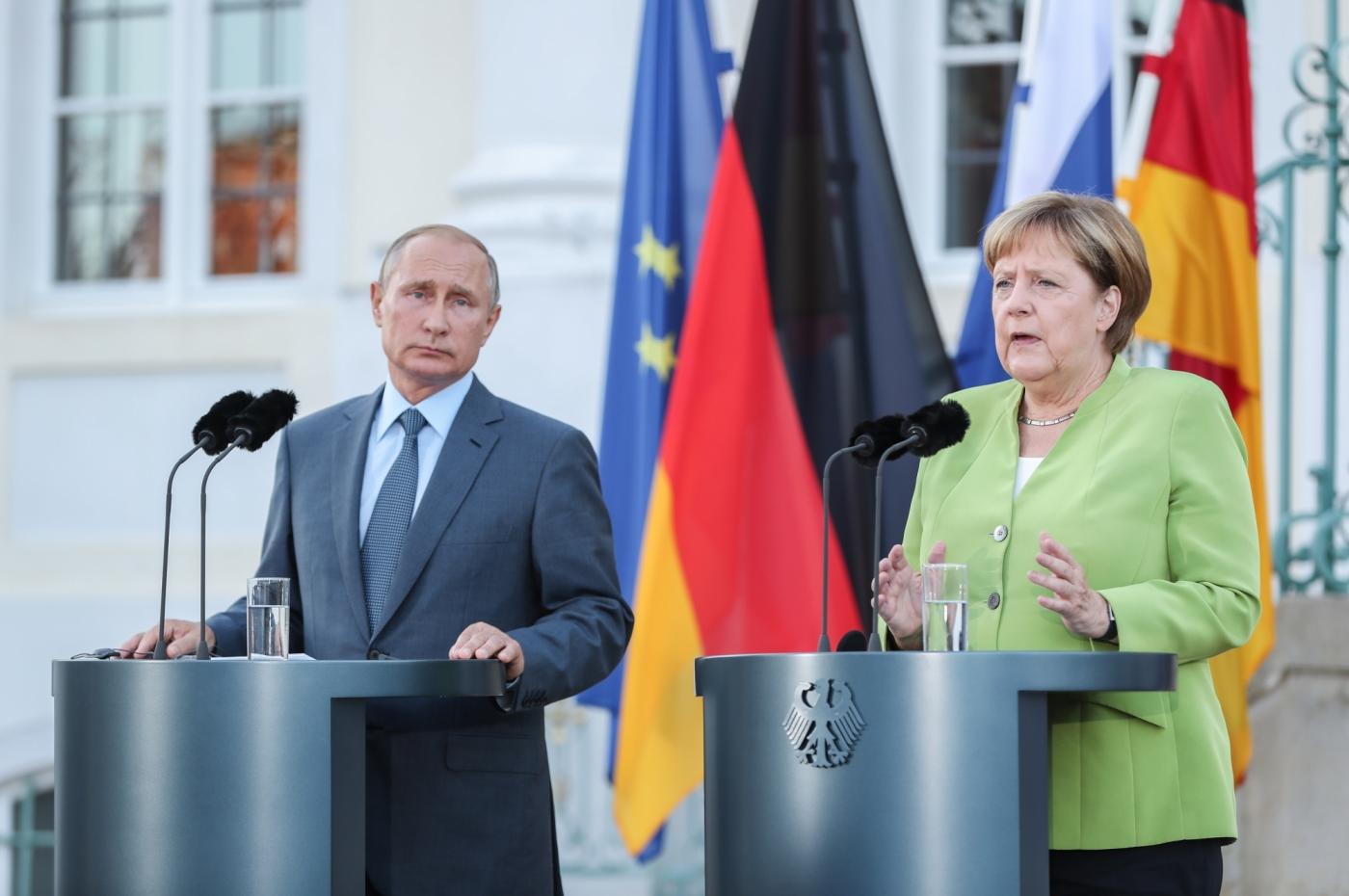 MESEBERG (GERMANY), Aug. 18, 2018 (Xinhua) -- German Chancellor Angela Merkel (R) and visiting Russian President Vladimir Putin attend a joint press conference at the Schloss Meseberg, north of Berlin, Germany, on Aug. 18, 2018. German Chancellor Angela Merkel and Russian President Vladimir Putin held talks in north of Berlin on Saturday, with the topics ranging from Syria, Ukraine, Iran as well as the Nord Stream 2 gas pipeline project. (Xinhua/Shan Yuqi/IANS) by .