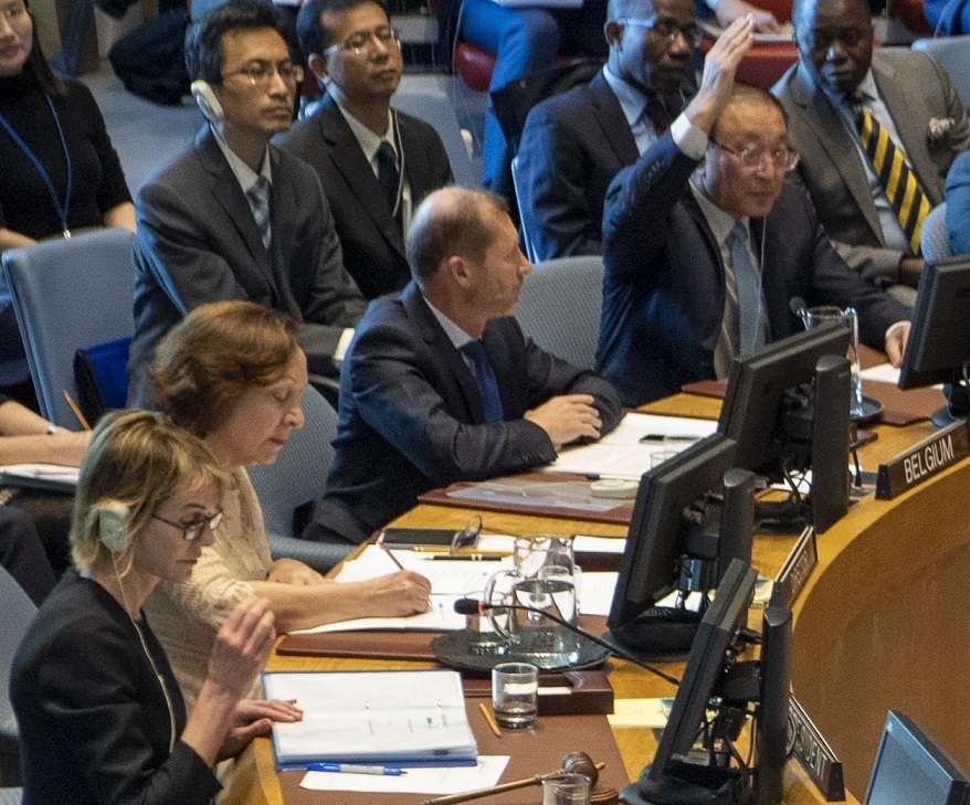 China's Permanent Representative Zhang Jun raises his hand at the United Nations Security Council to veto a resolution on keeping open entry points for humanitarian aid going to Syria on Friday, Dec. 20, 2019. United States Permanent Representative Kelly Craft, who is the Council president for December, is at left foreground. (Photo: UN/IANS) by .