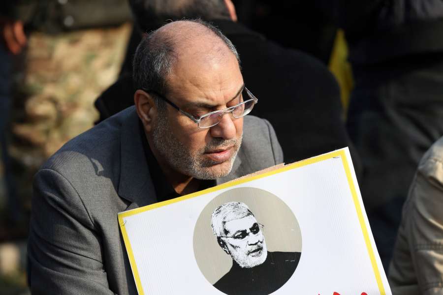 BAGHDAD, Jan. 4, 2020 (Xinhua) -- A mourner holds a picture of Abu Mahdi al-Muhandis, deputy chief of Iraq's paramilitary Hashd Shaabi forces, in Baghdad, Iraq, Jan. 4, 2020. Thousands of mourners on Saturday participated in a funeral of Qasem Soleimani, a senior Iranian commander, and Abu Mahdi al-Muhandis, deputy chief of Iraq's paramilitary Hashd Shaabi forces, who were killed in an U.S. airstrike in Iraq's capital Baghdad. (Xinhua/Khalil Dawood/IANS) by .