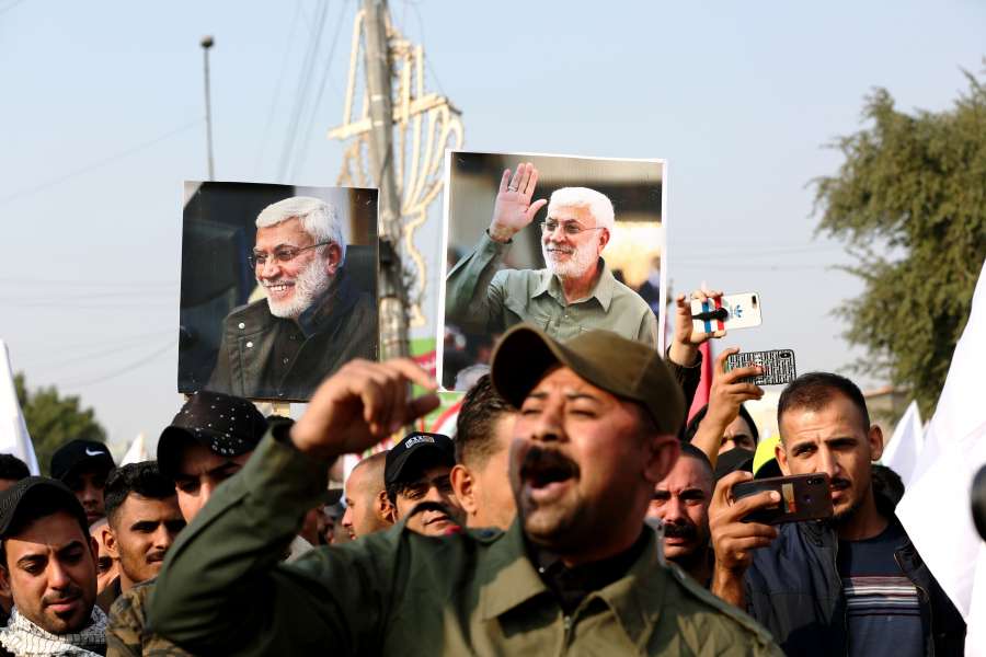 BAGHDAD, Jan. 4, 2020 (Xinhua) -- Mourners hold pictures of Abu Mahdi al-Muhandis, deputy chief of Iraq's paramilitary Hashd Shaabi forces, in Baghdad, Iraq, Jan. 4, 2020. Thousands of mourners on Saturday participated in a funeral of Qasem Soleimani, a senior Iranian commander, and Abu Mahdi al-Muhandis, deputy chief of Iraq's paramilitary Hashd Shaabi forces, who were killed in an U.S. airstrike in Iraq's capital Baghdad. (Xinhua/Khalil Dawood/IANS) by .