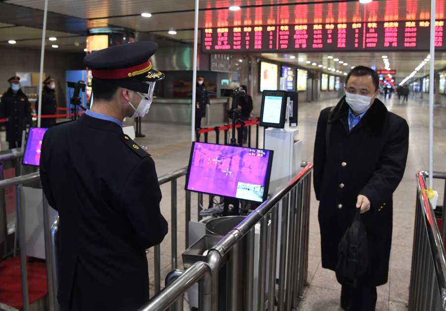 BEIJING, Feb. 2, 2020 (Xinhua) -- A staff member (L) checks a passenger's temperature at the exit of Beijing West Railway Station in Beijing, capital of China, Feb. 2, 2020. Chinese authorities have tightened measures to battle the novel coronavirus epidemic as a growing number of people hit the road and return to work after the Spring Festival holiday. (Photo by Ren Chao/Xinhua/IANS) by . 