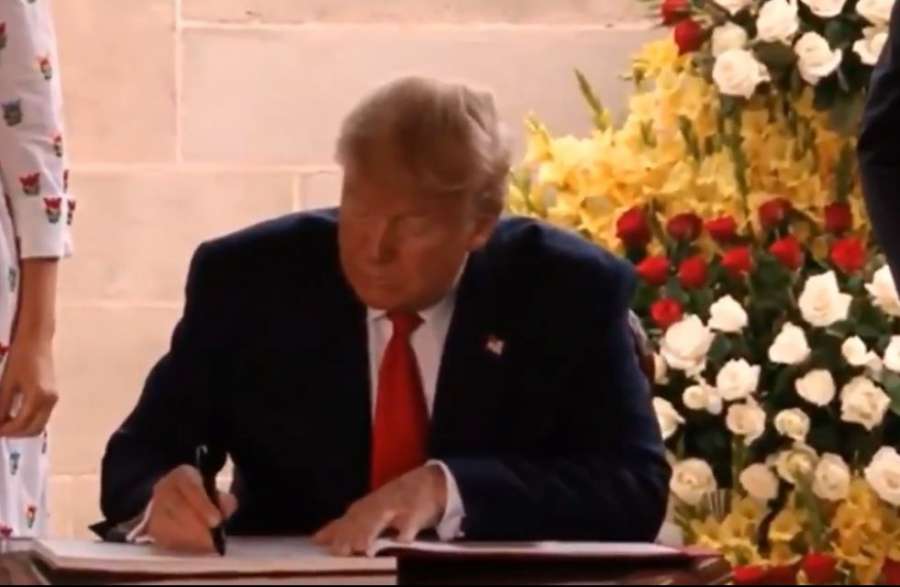 New Delhi: US President Donald Trump signs the Visitors Book of Raj Ghat after paying tributes to Mahatma Gandhi, in New Delhi on Feb 25, 2020. (Photo: IANS) by . 