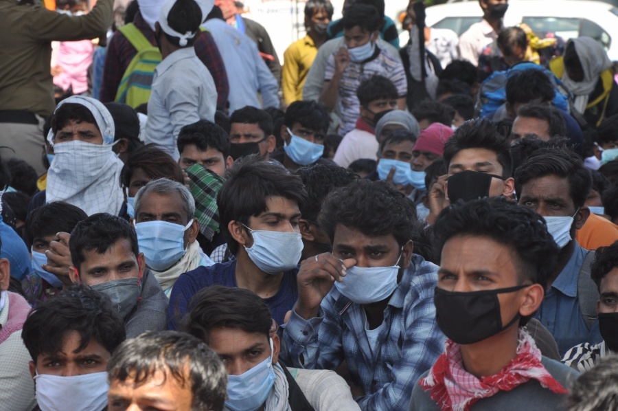 New Delhi: Scores of migrant workers heading back home seen at Anand Vihar bus terminal close to Delhi's border with Ghaziabad on Day 5 of the 21-day countrywide lockdown imposed to contain the spread of novel coronavirus, on March 29, 2020. (Photo: IANS) by . 