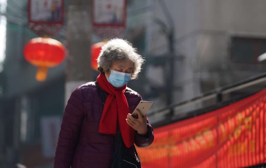 BEIJING, Feb. 12, 2020 (Xinhua) -- A resident checks information sent by community on her phone in Wuchang District of Wuhan, the epicenter of the novel coronavirus outbreak in central China's Hubei Province, Feb. 9, 2020. (Xinhua/Cheng Min/IANS) by . 