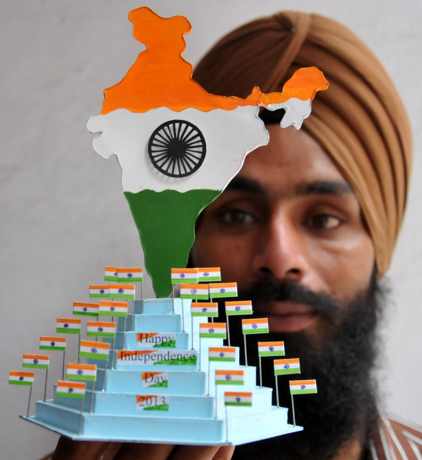 Paper artist Gurpreet Singh showing Indian map and flags made of paper for forthcoming Independence Day celebrations in Amritsar on August 13, 2013. (Photo::: IANS) by .