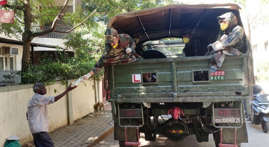 Bengaluru: Army personnel distribute food packages among the needy on Day 5 of the 21-day countrywide lockdown imposed to contain the spread of novel coronavirus, in Bengaluru on March 29, 2020. (Photo: IANS) by . 