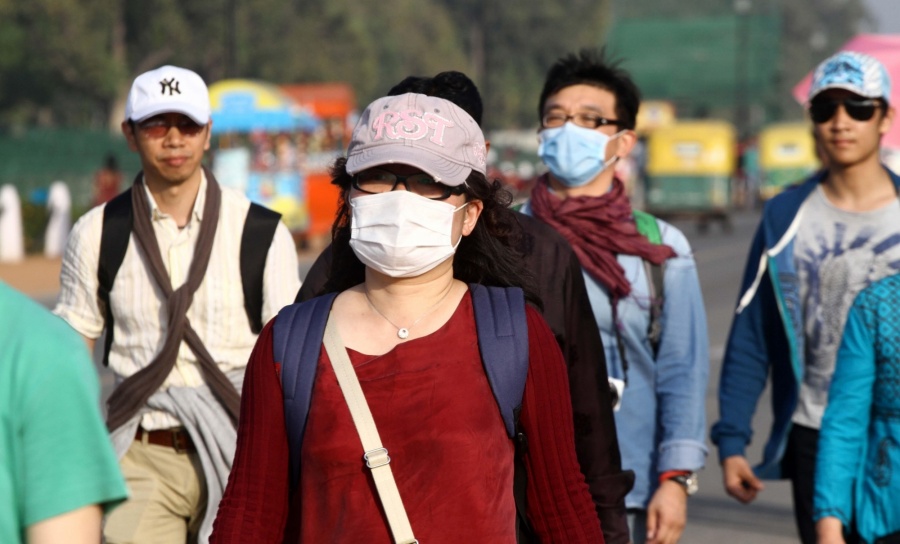 People wearing masks as a precautionary measure against swine flu. (File Photo: IANS) by . 