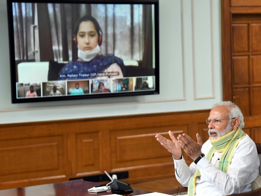 New Delhi: Prime Minister Narendra Modi interacts with the Sarpanchs from across the country on the occasion of the National Panchayati Raj Divas through video-conferencing during the extended nationwide lockdown imposed to mitigate the spread of coronavirus; in New Delhi on Apr 24, 2020. Also present at the interaction was Union Agriculture and Farmers Welfare Minister Narendra Singh Tomar. (Photo: IANS/PIB) by . 