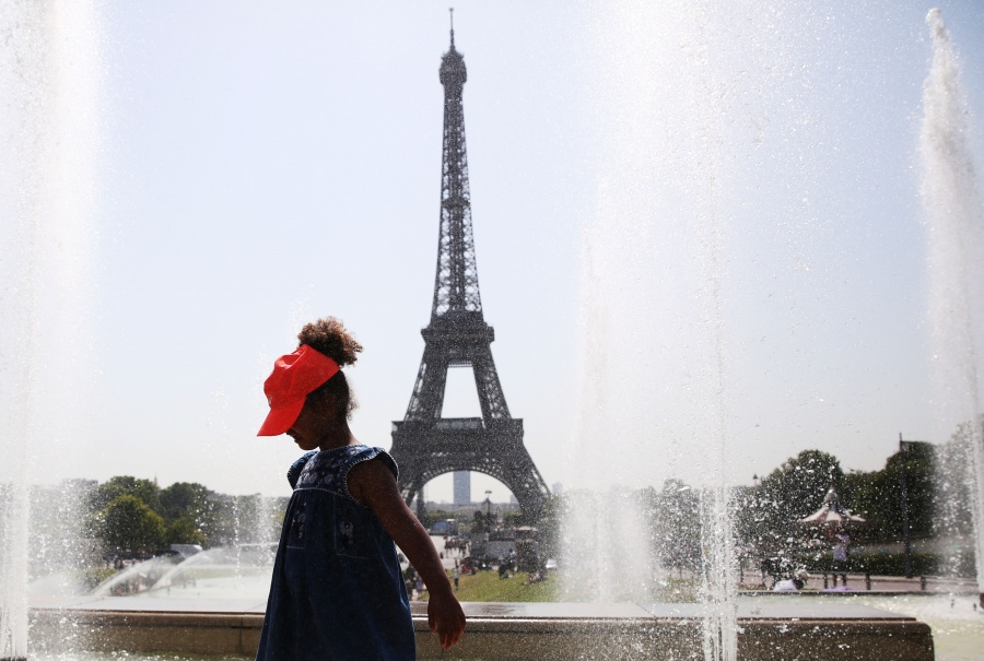 PARIS, July 25, 2019 (Xinhua) -- A girl poses for a photo with the Eiffel Tower on the backdrop by a fountain at the Trocadero Place in Paris, France, July 25, 2019. Temperature in Paris hit 42 degrees centigrade on Thursday. (Xinhua/Gao Jing/IANS) by .
