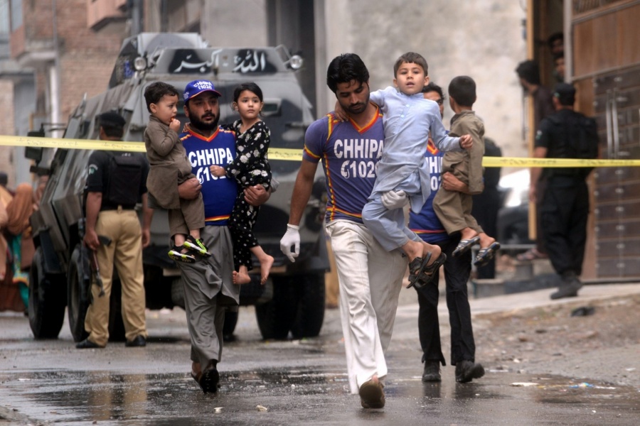 Rescuers evacuate children near the site of an operation in Peshawar, Khyber Pakhtunkhwa province (Xinhua/Umar Qayyum/IANS) by . 