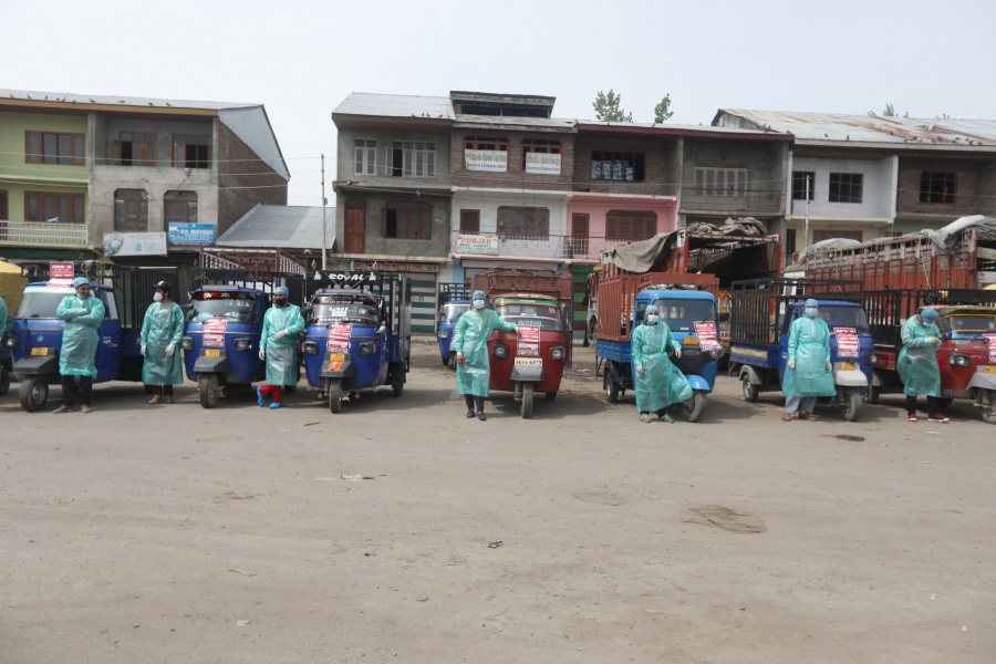 Srinagar: A fleet of cargo autos with their drivers wearing Personal Protective Equipment (PPE) suits ready to deliver essential commodities across Srinagar during the extended nationwide lockdown imposed to mitigate the spread of coronavirus pandemic, on Apr 16, 2020. (Photo: IANS) by . 
