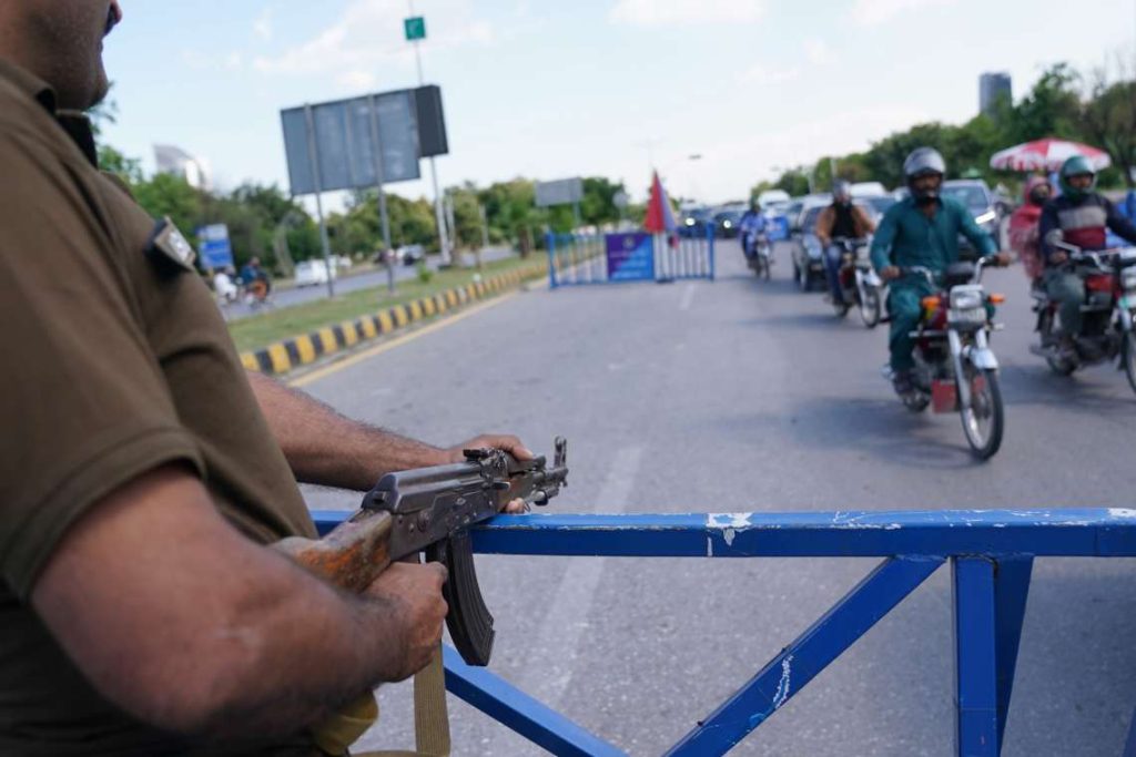Security personnel stand guard at a checkpoint Pakistan