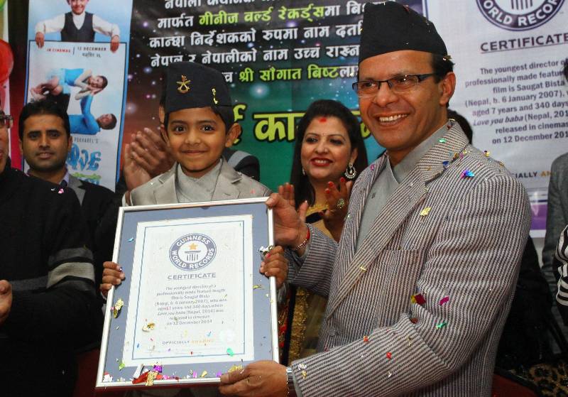 Nepalese eight-year-old kid Saugat Bista (L, front) shows the certificate of Guinness World Records for World's Youngest Director in Kathmandu, Nepal, Feb. 20, 2015. Bista had broken the record of Indian Kid Kishan Shrikanth who directed a feature film at the age of 9 by directing a movie "Love you Baba" at an age of 7 years 340 days