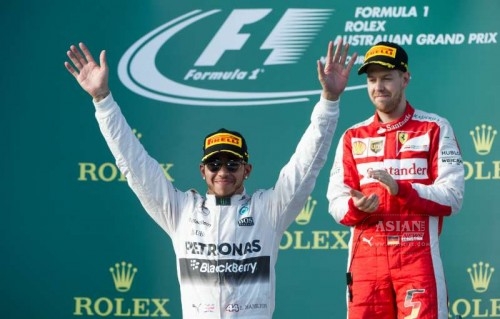  Scuderia Ferrari Formula One driver Sebastian Vettel of Germany reacts as Mercedes AMG Petronas Formula One driver Lewis Hamilton of Britain (L) celebrates after winning the Australian Formula One Grand Prix at the Albert Park circuit in Melbourne, Australia, March 15, 2015. Lewis Hamilton won the Australian Formula One Grand Prix by clocking at 1:31.54.067. 