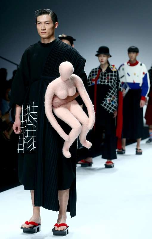 Model presents a creation by graduates of Tsinghua University and Milano Nuova Accademia di Belle Arti (NABA) during the 2015 China Graduate Fashion Week in Beijing, capital of China