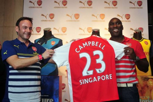 Former Arsenal player Sol Campbell (R) attends the Arsenal's new kit launch in Singapore