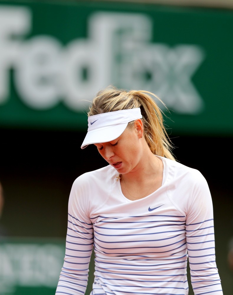 Maria Sharapova of Russia reacts during the women's singles fourth round match against Lucie Safarova of Czech Republic at 2015 French Open tennis tournament at Roland Garros, in Paris, France, on June 1, 2015. Sharapova lost 0-2 and was disqualified for the quarterfinal