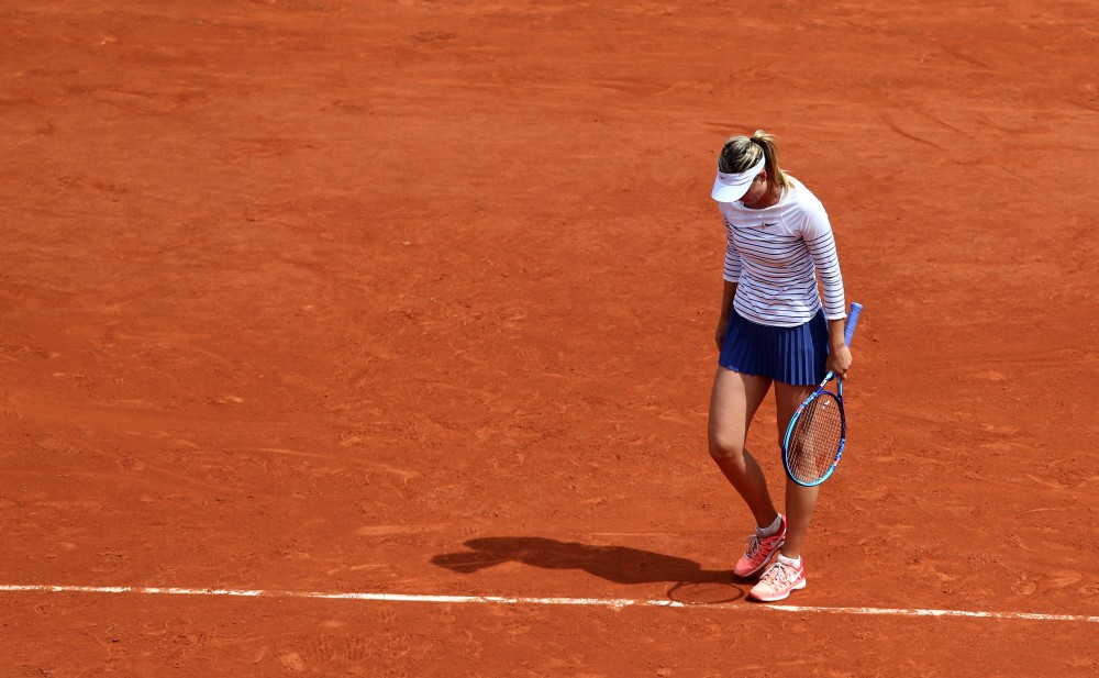 Maria Sharapova of Russia reacts during the women's singles fourth round match against Lucie Safarova of Czech Republic at 2015 French Open tennis tournament at Roland Garros, in Paris, France, on June 1, 2015. Sharapova lost 0-2 and was disqualified for the quarterfinal.